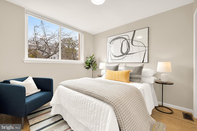 bedroom with wood-type flooring