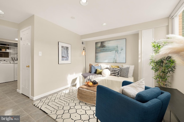 sitting room with light tile patterned floors and washer and dryer