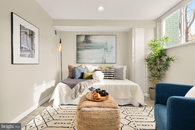 bedroom with light tile patterned floors