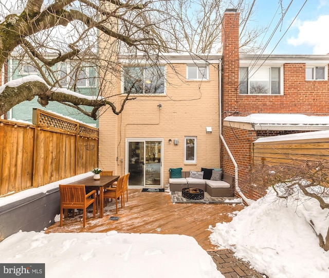 snow covered property featuring an outdoor hangout area and a wooden deck