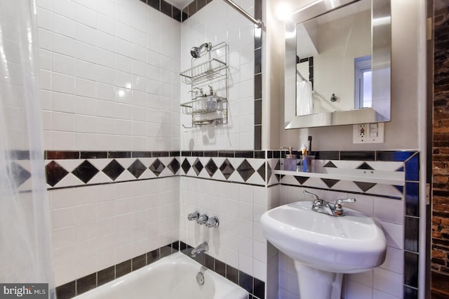 bathroom with shower / bath combination and a sink