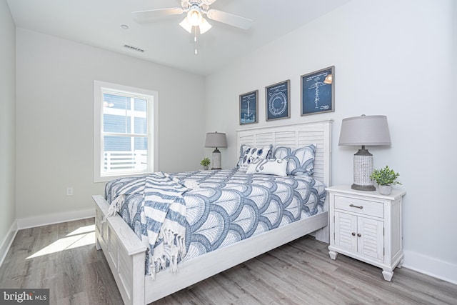 bedroom with ceiling fan and light hardwood / wood-style flooring