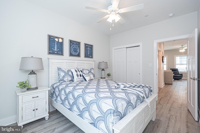 bedroom featuring light wood-type flooring, a closet, and ceiling fan