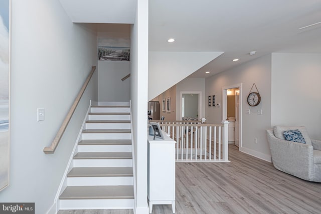 stairway with hardwood / wood-style floors