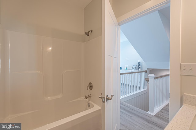 bathroom with hardwood / wood-style floors and shower / bath combination