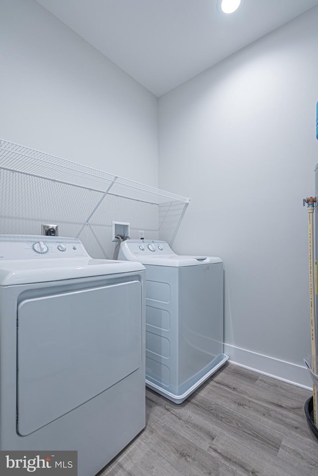 laundry area featuring light hardwood / wood-style flooring and independent washer and dryer