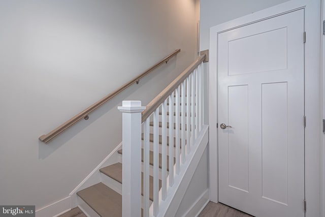 stairway featuring hardwood / wood-style floors