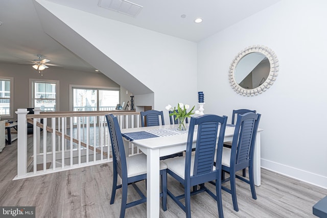 dining area with hardwood / wood-style flooring and ceiling fan