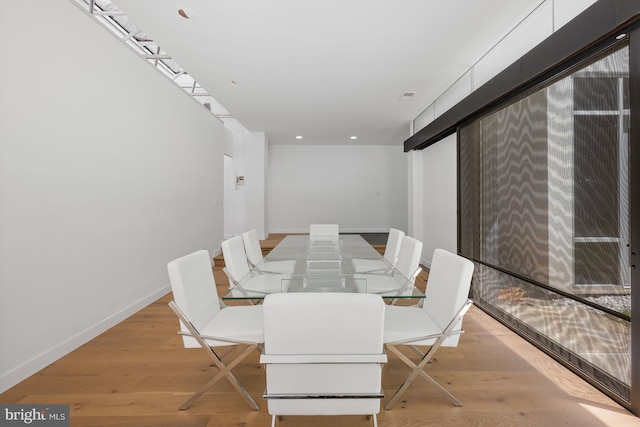 dining room featuring baseboards and light wood finished floors