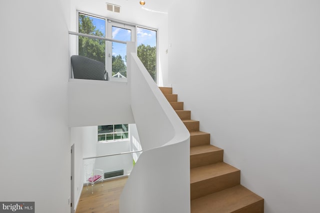 stairs featuring visible vents and wood finished floors