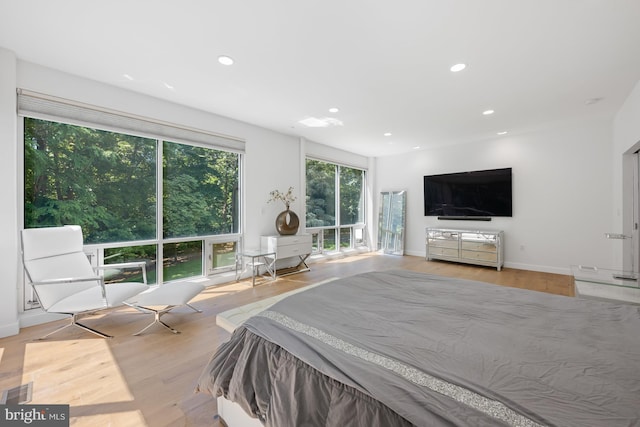 bedroom featuring recessed lighting, visible vents, baseboards, and wood finished floors