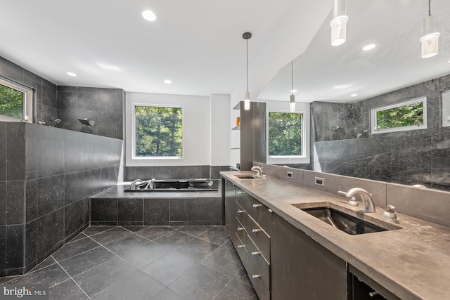 bathroom with a bath, tile walls, walk in shower, and a sink