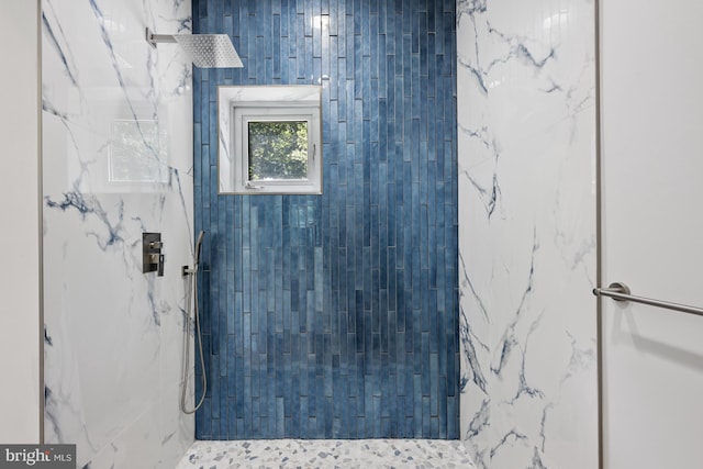 full bathroom featuring a marble finish shower