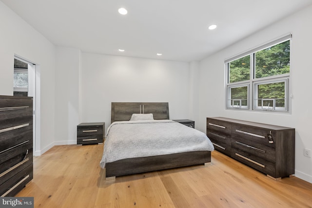 bedroom with recessed lighting, baseboards, and light wood finished floors