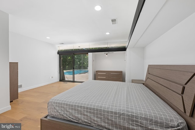 bedroom with baseboards, visible vents, wood finished floors, access to exterior, and recessed lighting