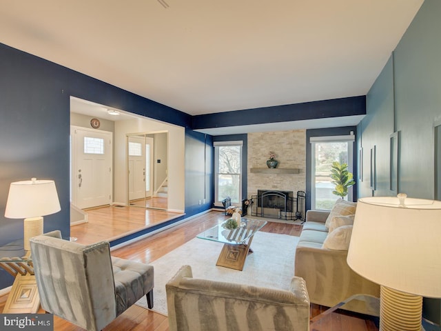 living room with light wood-type flooring and a fireplace