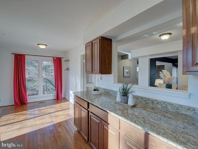 kitchen featuring light stone countertops and light hardwood / wood-style floors