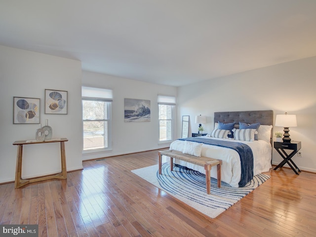 bedroom featuring light wood-type flooring and multiple windows