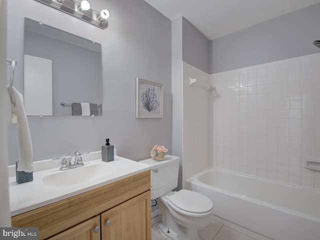 full bathroom featuring tiled shower / bath, tile patterned flooring, vanity, and toilet