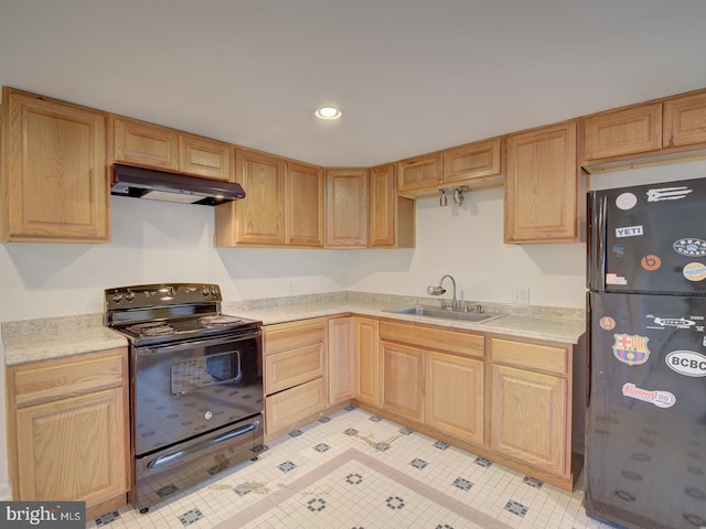 kitchen featuring black appliances, sink, and light brown cabinetry