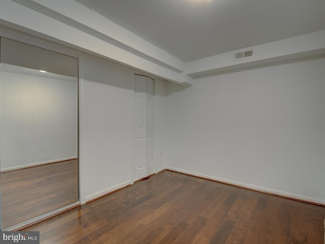 basement with dark hardwood / wood-style floors