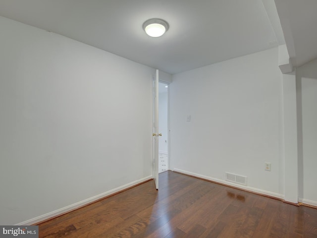 empty room with dark wood-type flooring