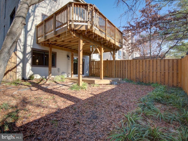 back of house featuring a wooden deck