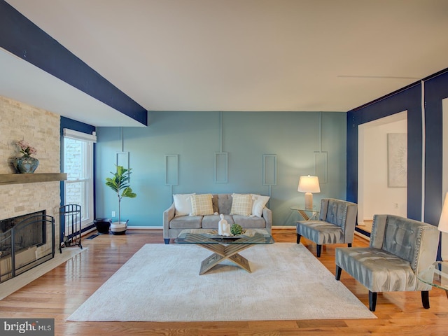 living room featuring a fireplace and wood-type flooring