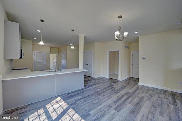 kitchen featuring sink, pendant lighting, and light hardwood / wood-style flooring