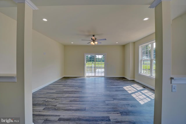 unfurnished room with hardwood / wood-style floors, ceiling fan, and a wealth of natural light