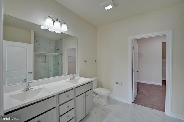 bathroom with vanity, a shower with shower door, and toilet