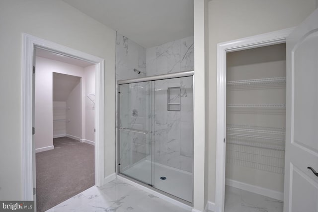 bathroom with a shower with shower door