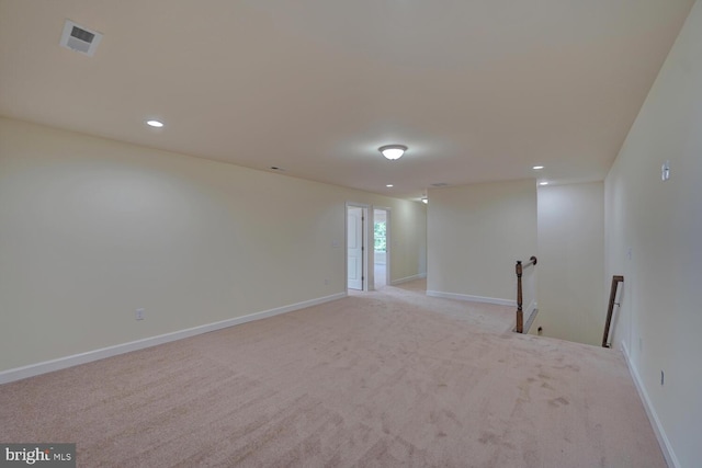 unfurnished room featuring light carpet