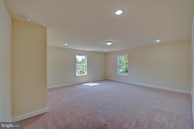 unfurnished room with light carpet