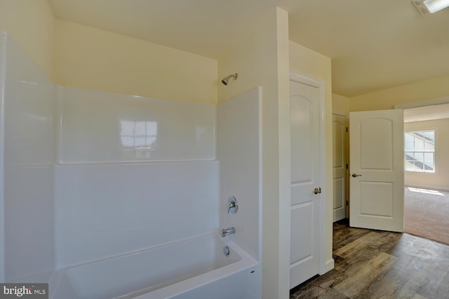 bathroom featuring shower / bathtub combination and hardwood / wood-style flooring