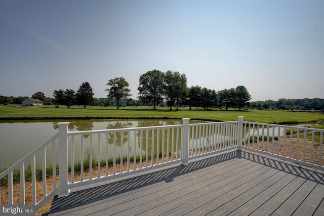 deck with a yard and a water view