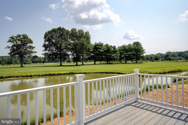 wooden terrace featuring a water view