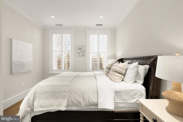 bedroom with hardwood / wood-style floors and crown molding