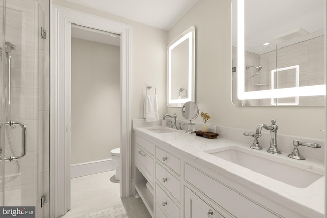 bathroom with tile patterned flooring, vanity, toilet, and an enclosed shower