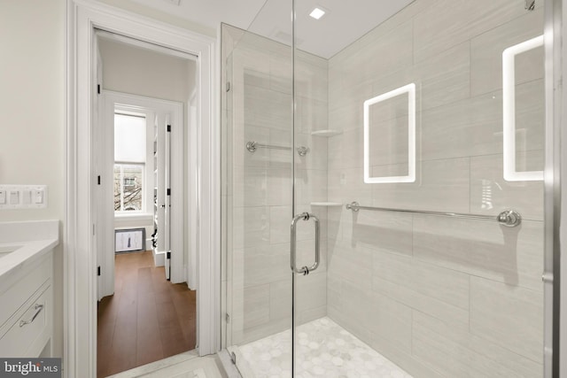 bathroom featuring vanity and an enclosed shower