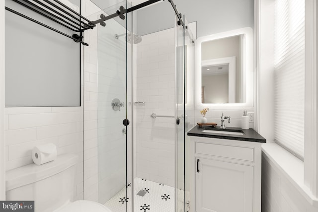 bathroom with vanity, an enclosed shower, and toilet