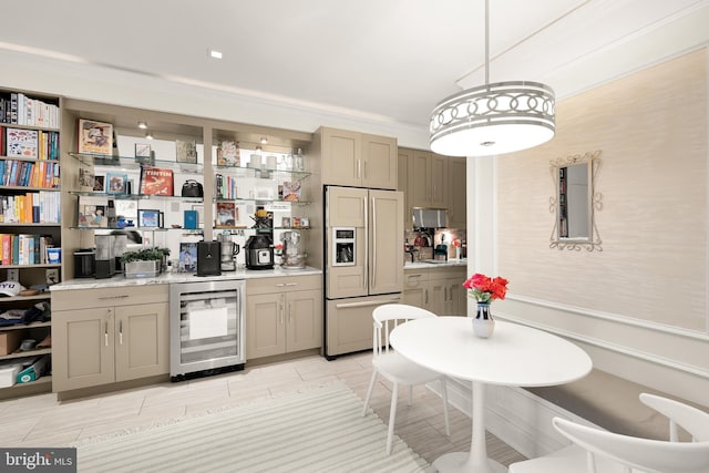 kitchen featuring paneled built in refrigerator, crown molding, hanging light fixtures, and beverage cooler