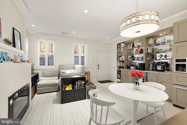 dining room featuring crown molding and beverage cooler