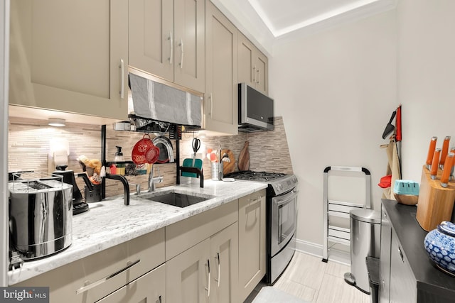 kitchen with sink, appliances with stainless steel finishes, tasteful backsplash, light tile patterned flooring, and light stone counters