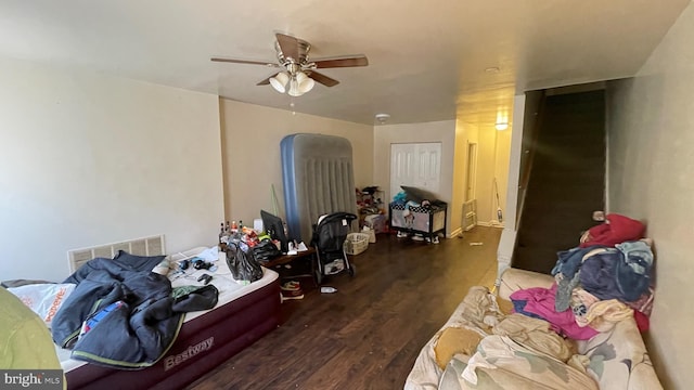 bedroom with dark hardwood / wood-style floors and ceiling fan