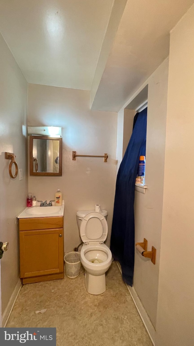 bathroom featuring vanity and toilet