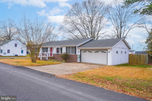 ranch-style home with a front yard and a garage