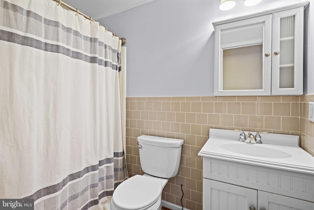 bathroom featuring tile walls, vanity, and toilet