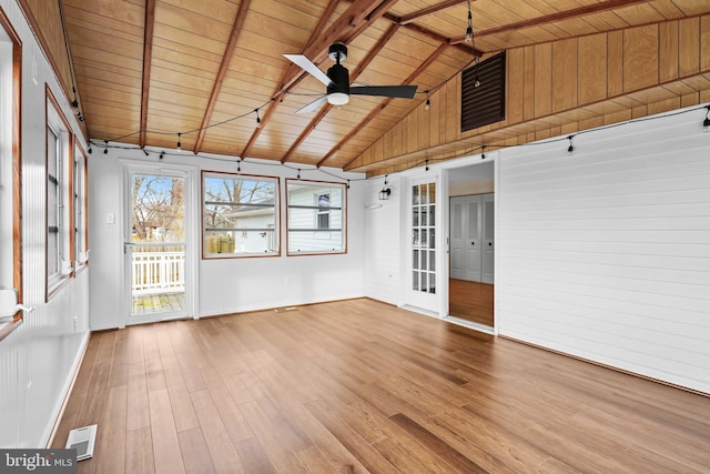 unfurnished sunroom with lofted ceiling with beams, ceiling fan, and wood ceiling