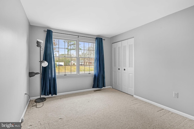 unfurnished bedroom featuring a closet and carpet floors